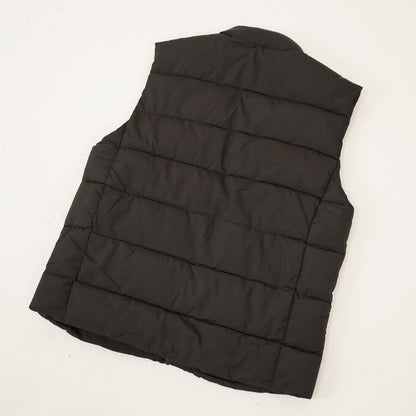 Veste chauffante sans manches noire, vue de dos posée à plat
